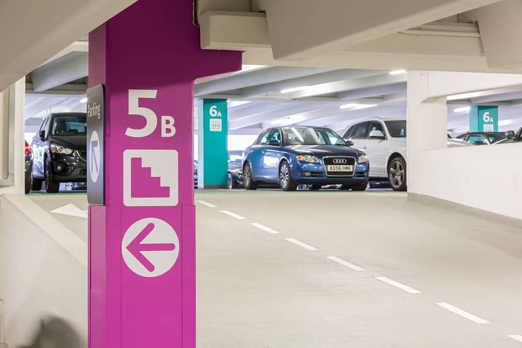 View up a ramp in Trinity Leeds shopper car park showing how colour is used to differentiate between floor levels