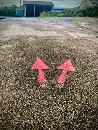 Example of low tech wayfinding design - Painted arrows on tarmac - Orford Ness