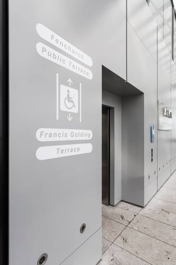 Lift index sign for disabled access applied to the external wall of the elevator lobby