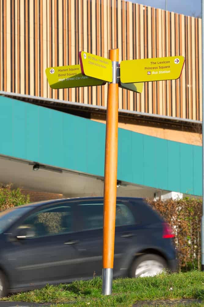 Fingerpost directional prompt signs designed as part of The Lexicon, Bracknell's wayfinding scheme. Using the aubergine and lime brand colours with wooden posts to align with the architecture