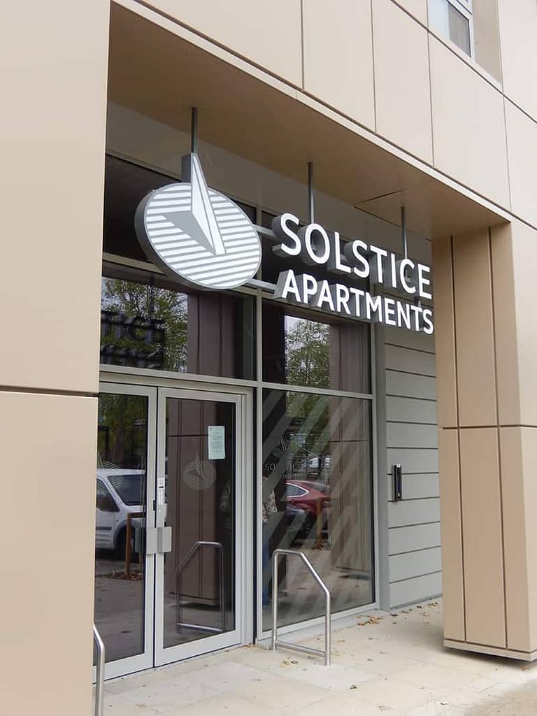 Entrance sign over the door at Solstice Apartments