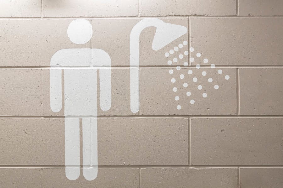 Large supergraphic of a shower and a male toilet symbol painted directly on the wall in the basement of 20 Fenchurch St